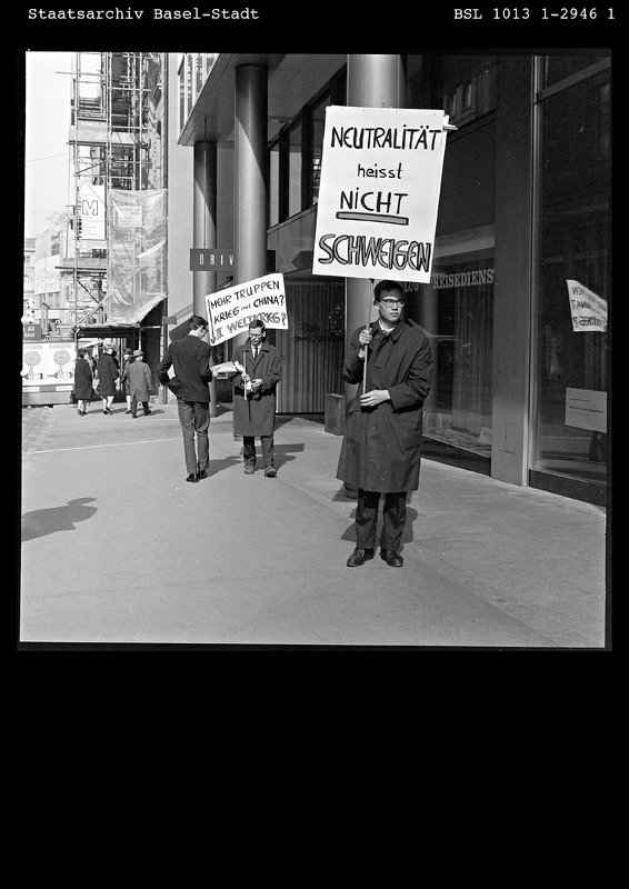 Der Protest gegen den Vietnamkrieg wurde eines der Hauptanliegen der Studentenbewegung in den USA und Westeuropa. Damit gewann die Antikriegsbewegung erstmals seit 1945 wieder eine internationale gesellschaftliche Relevanz. Auch in Basel stand die Solidarität mit dem Befreiungskampf der ‹Kommunistischen Nationalen Front für die Befreiung Südvietnams› für den Kampf gegen das politische Establishment und war zentral für die Definition einer neuen politischen Identität. Am 9. März 1966 demonstrierten zwei Studenten, ein Basler und ein Amerikaner, vor dem US-Konsulat an der Freien Strasse gegen den Vietnam-Krieg (National-Zeitung, 10.03.1966).