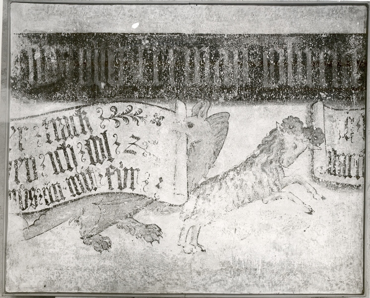 Das Zeughaus, fertiggestellt im Jahr 1440, wurde 1474 mit Wandmalereien versehen, welche die Positionen der städtischen Geschütze festhielten. Die Geschütze trugen Namen wie Rennerin, Drache oder Widder. Letzteren zeigt der abgebildete Ausschnitt. Das beigegebene Spruchband lässt ihn verkünden: «Ich heiß der Widder, mein starkes Schießen hilft machen Frieden» (KDS BS, Bd. 5, S. 134). Das separat laufende dunkle (rote) Band aus der Zeit um 1440 verzeichnete die Namen der Ratsherren, denen die Basler Bevölkerung den Neubau zu verdanken hatte.